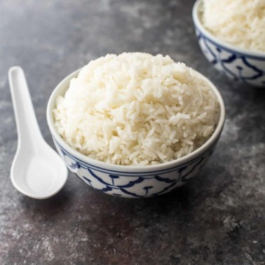 a bowl of jasmine rice on a grey countertop