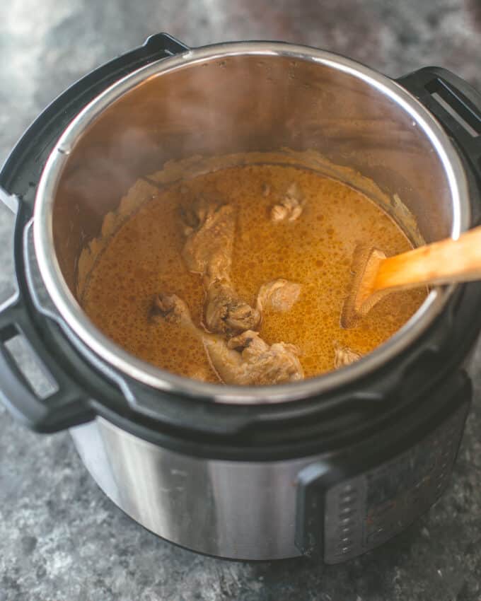 cooking chicken and curry paste in an instant pot