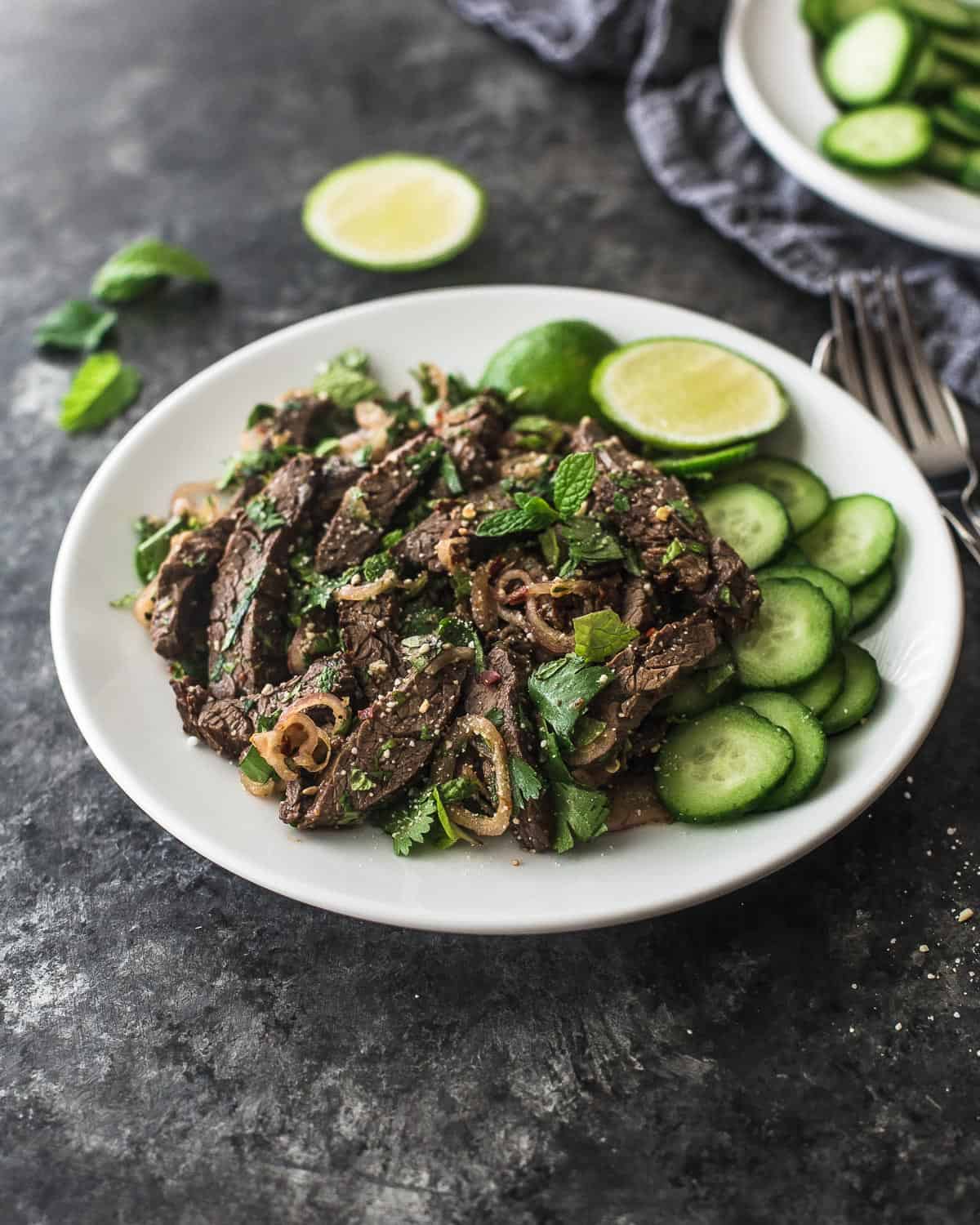 Thai beef salad on a white plate