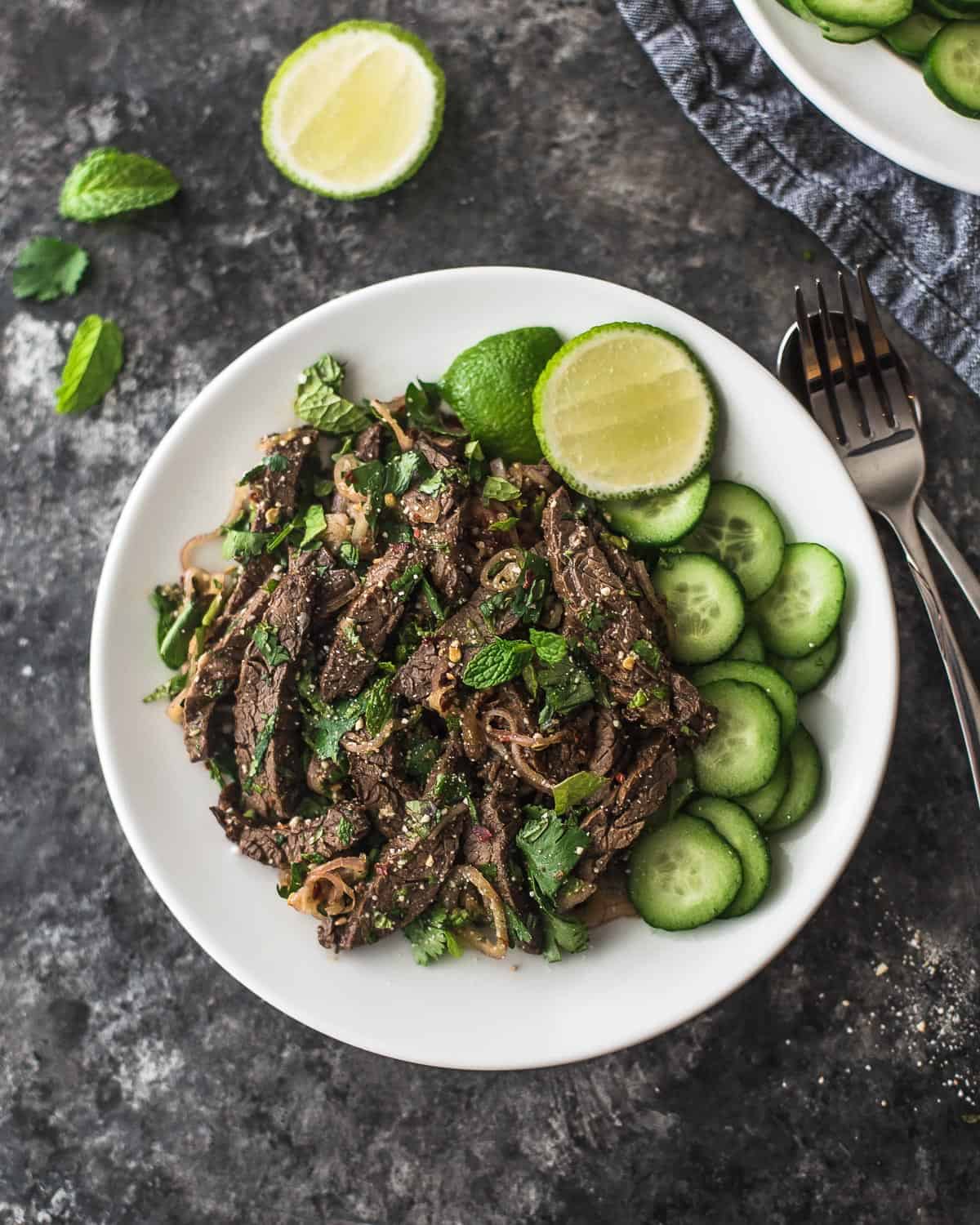 overhead image of thai beef salad on a white plate