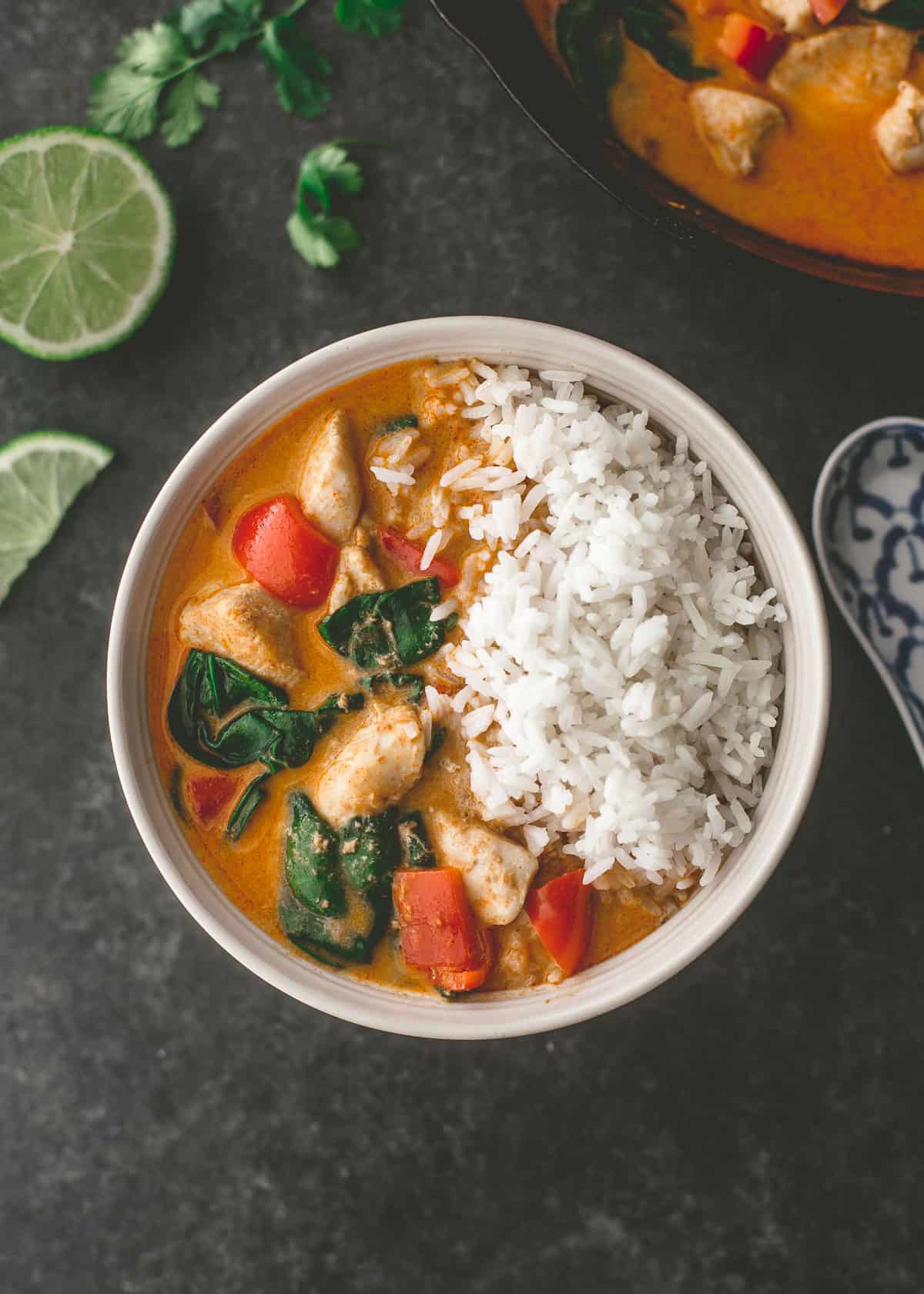 coconut chicken curry in a white bowl with rice