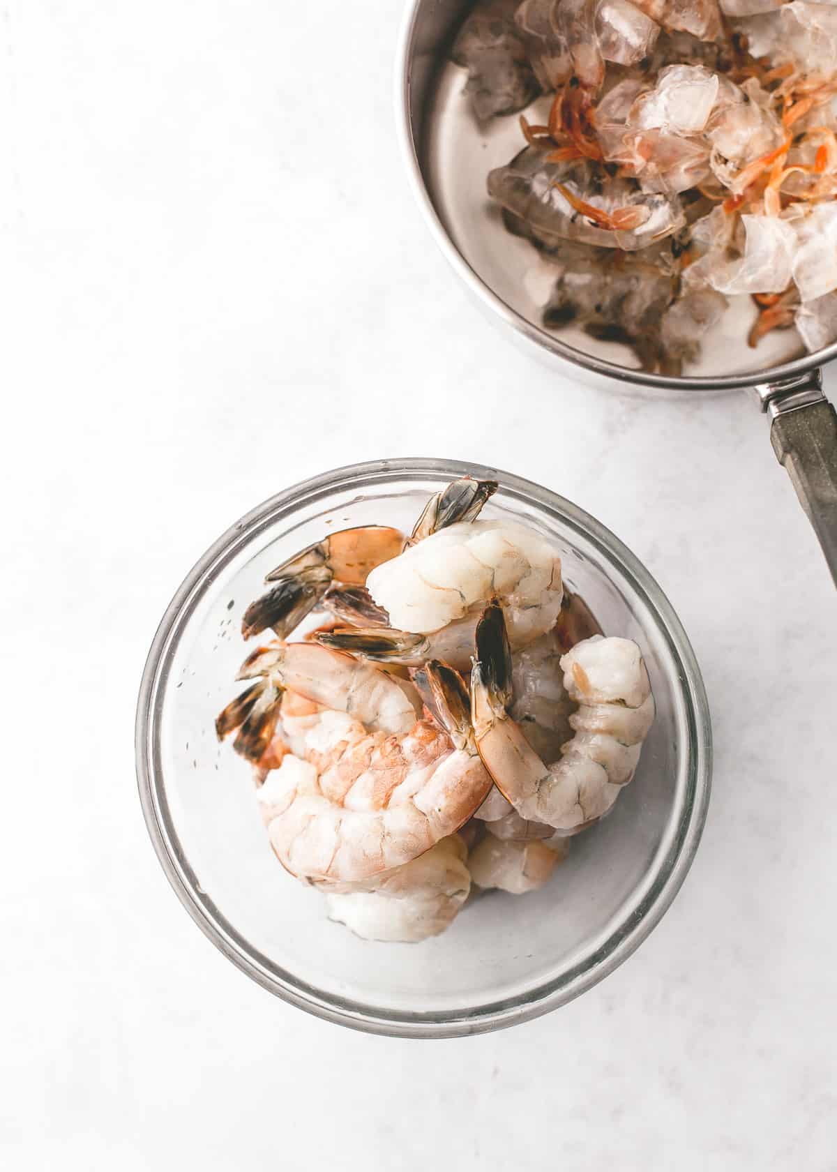 overhead image of uncooked shrimp in a clear bowl