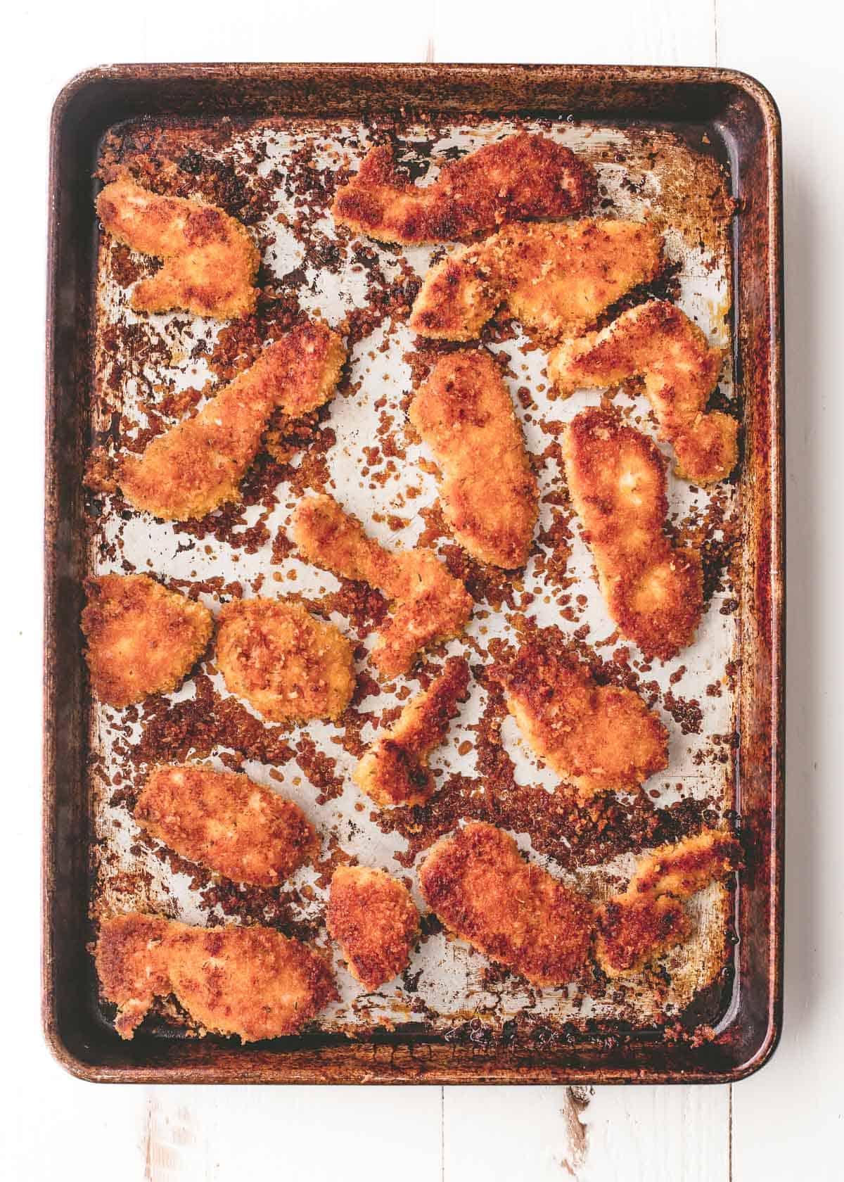 overhead image of baked chicken on a sheet pan