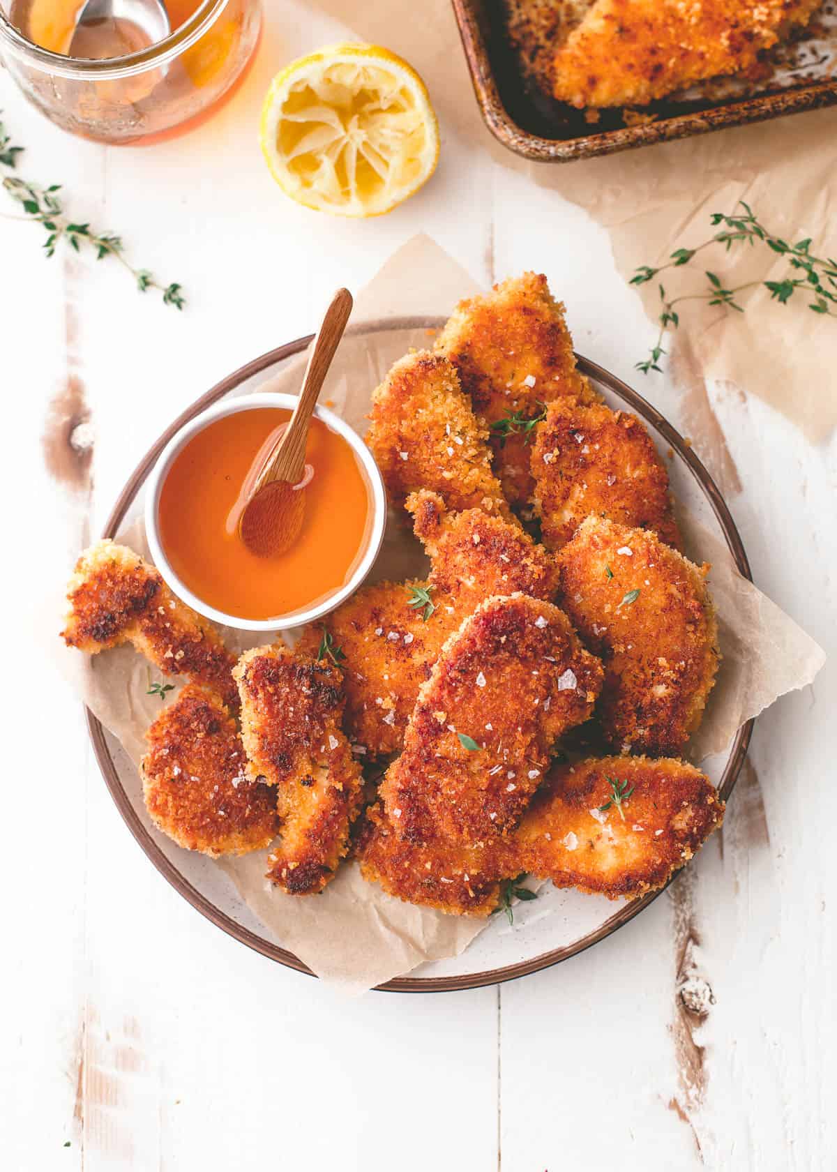 overhead image of baked chicken with honey on a white plate