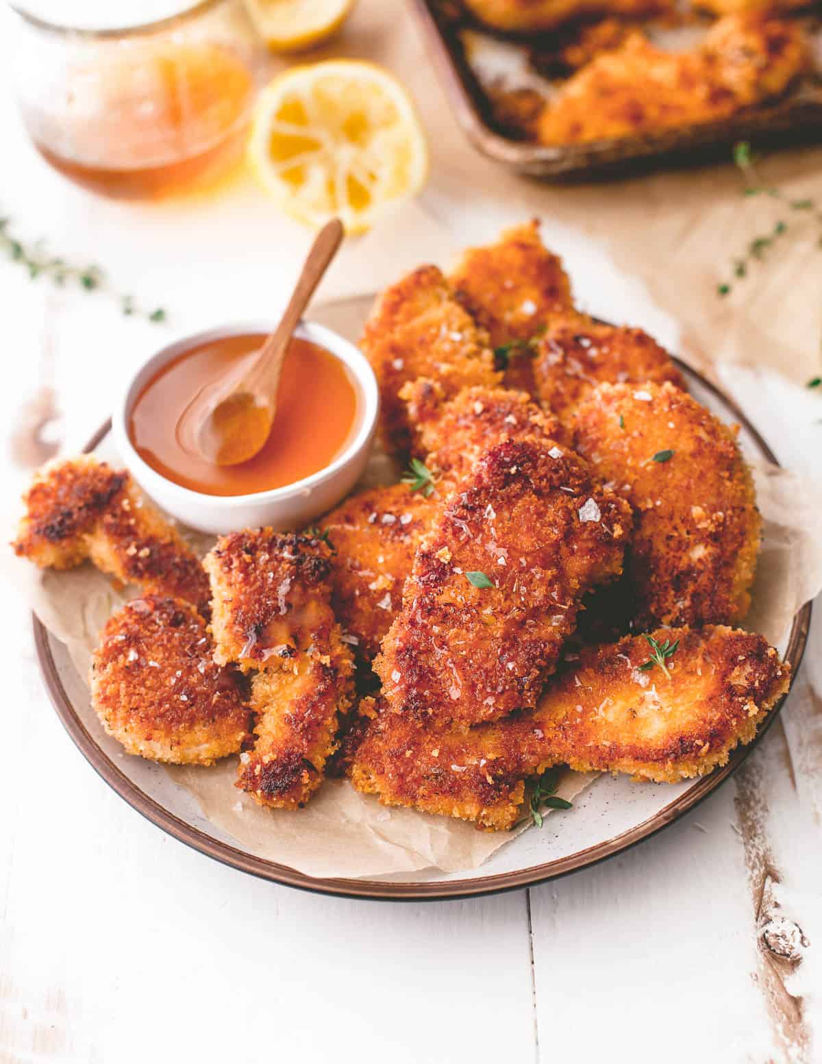baked chicken tenders with spicy honey on a white plate