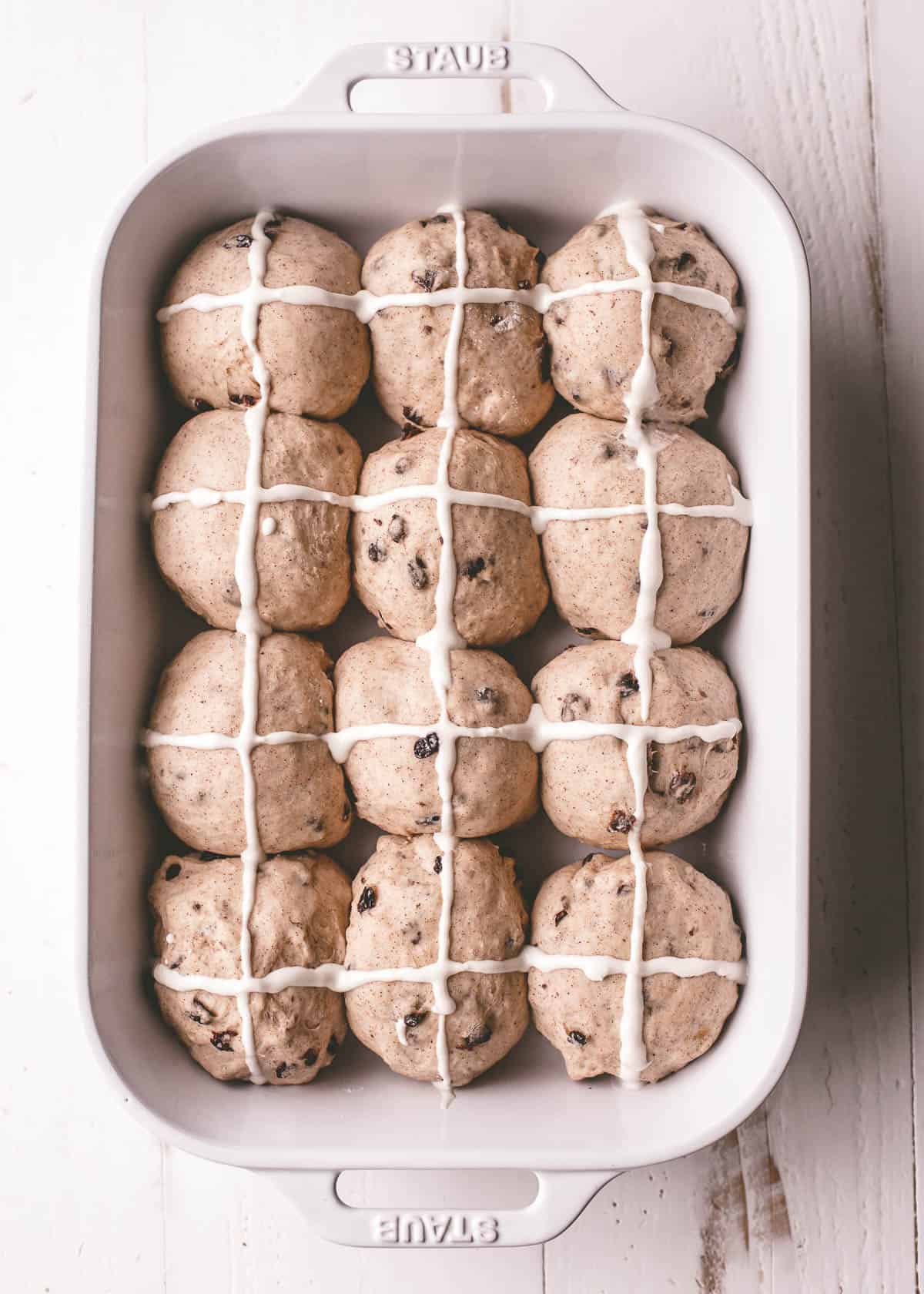 overhead image of unbaked buns in a rectangular white baking dish