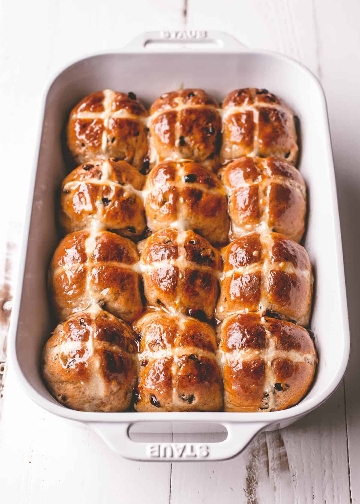 overhead image of baked buns in a white baking dish