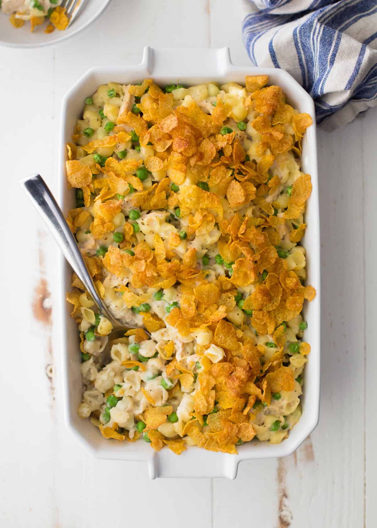 overhead image of tuna casserole in a white rectangular baking dish on a white table