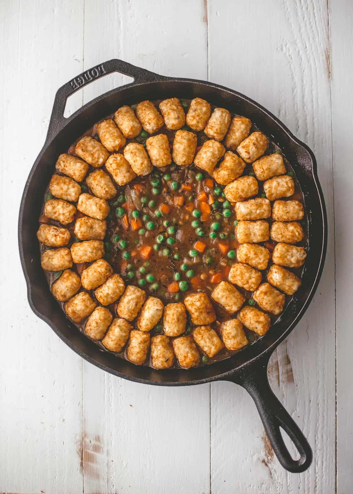 lining a cast iron skillet with tater tots