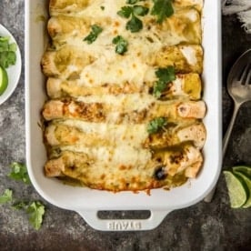 enchiladas in a white baking dish