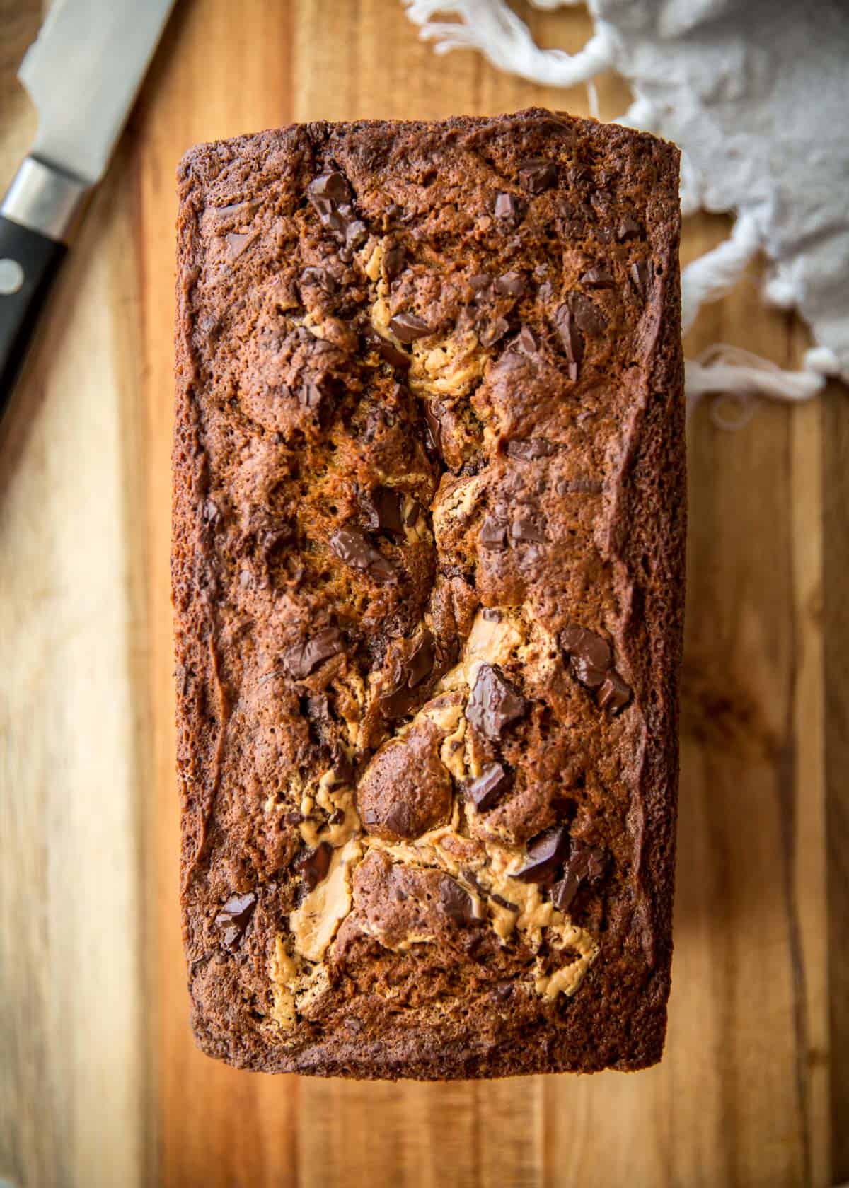 overhead image of chocolate peanut butter banana bread on a wooden cutting board