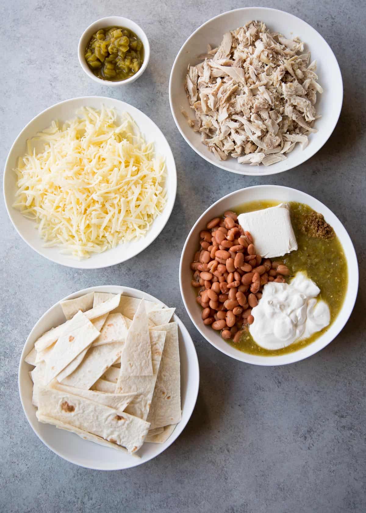 ingredients for chicken casserole in white bowls