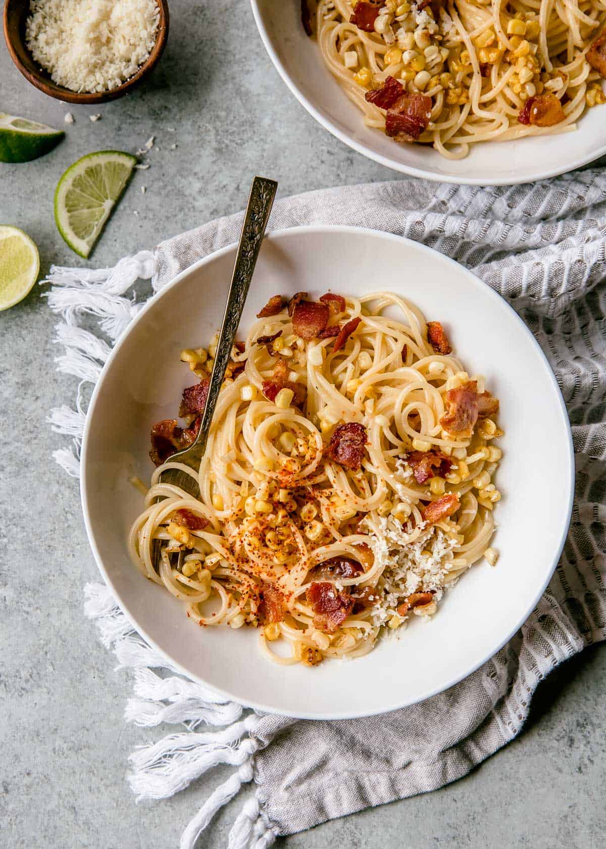 overhead image of pasta and a spoon in a large white bowl