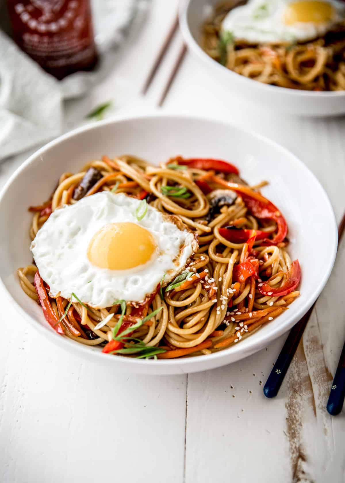 noodles in a white bowl with a fried egg