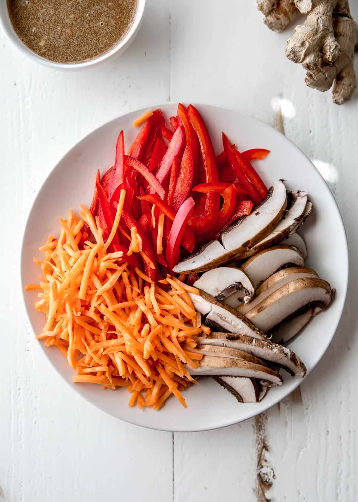 overhead image of sliced vegetables on a white plate