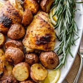 chicken and potatoes on a white plate