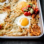 eggs, potatoes and salsa on a sheet pan