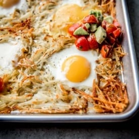 eggs, potatoes and salsa on a sheet pan