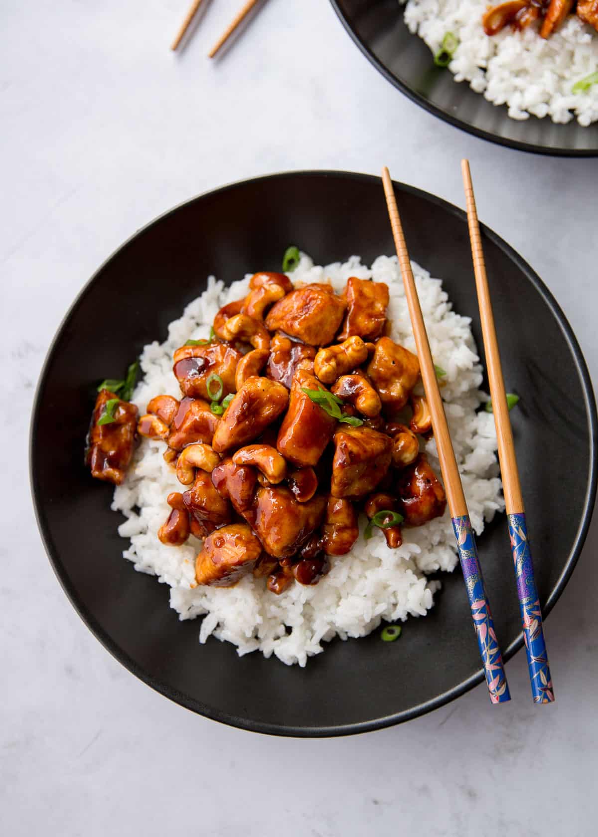 overhead image of chicken and rice in a black bowl