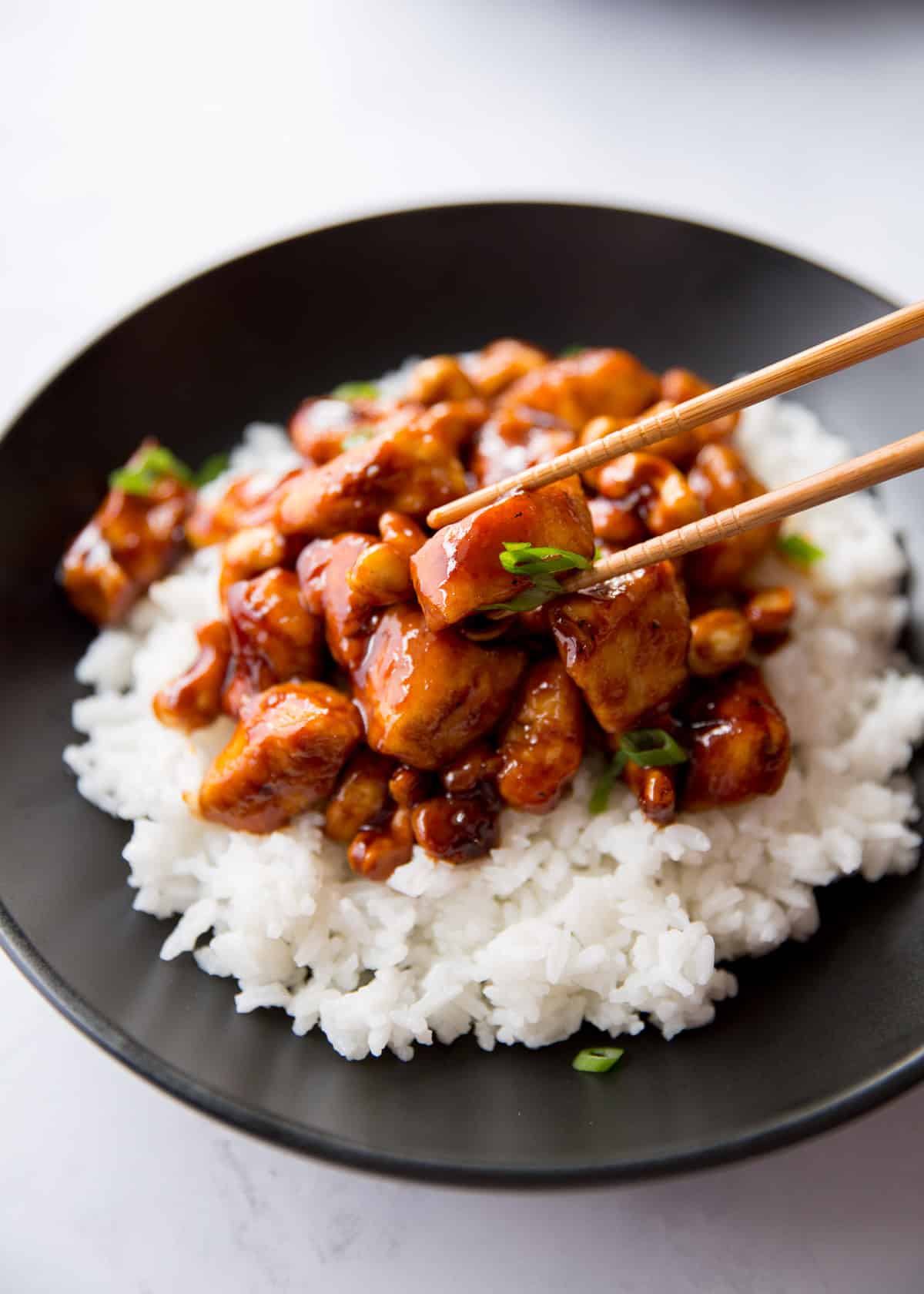 eating chicken and rice with chopsticks