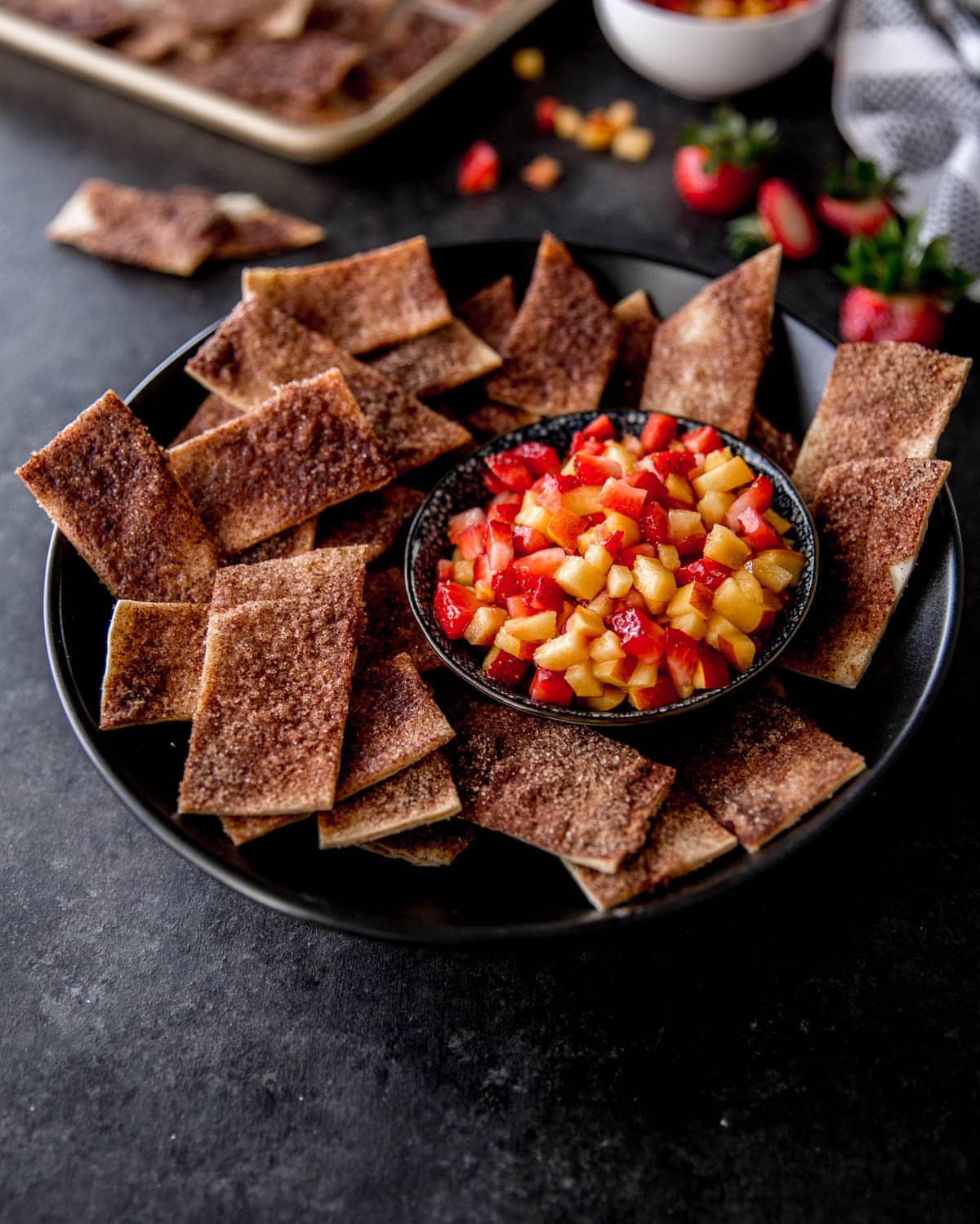 salsa and cinnamon chips in a black bowl