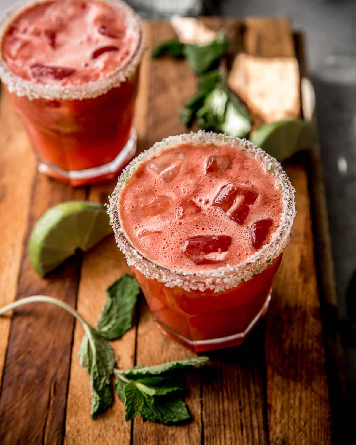 watermelon margaritas in a clear glass on a wooden table