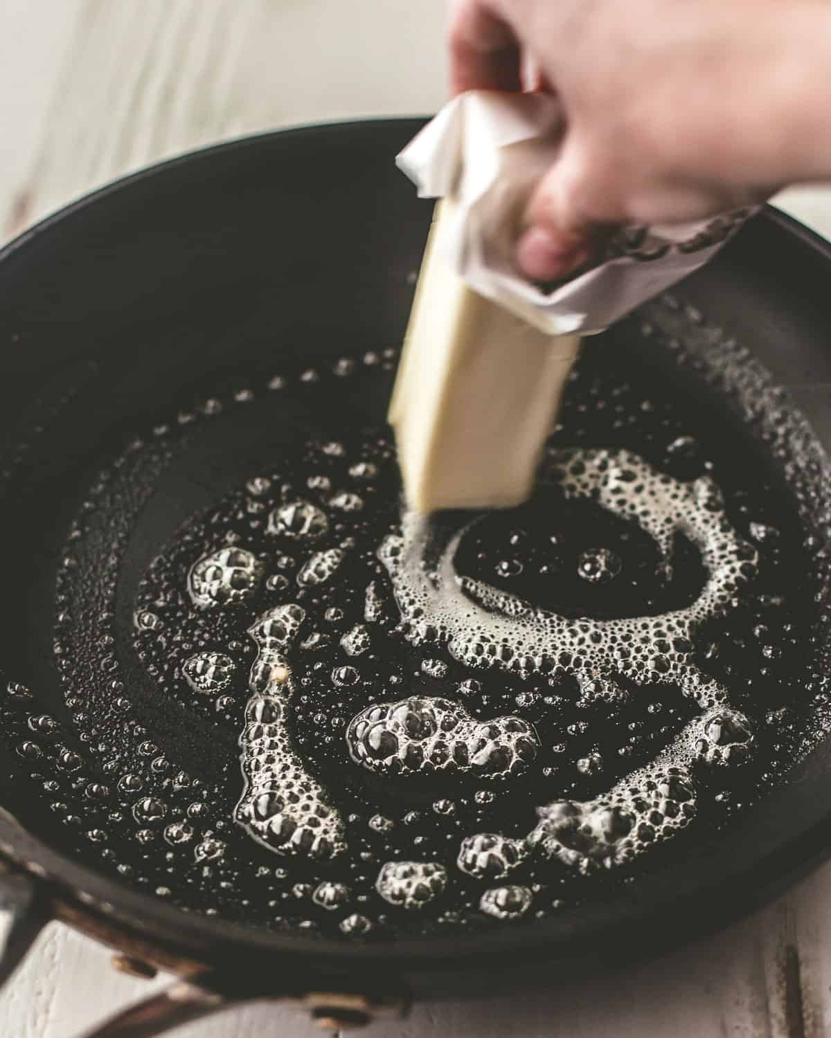 melting a stick of butter in a skillet