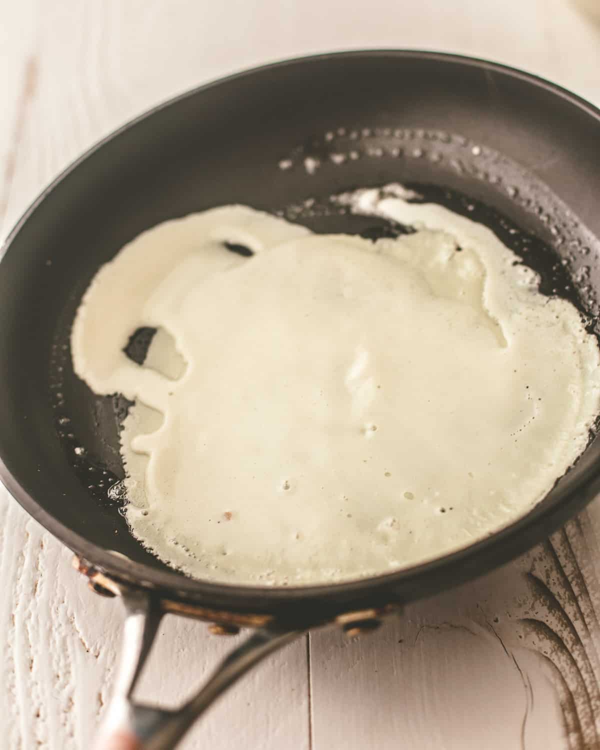 overhead image of batter in a cast iron skillet