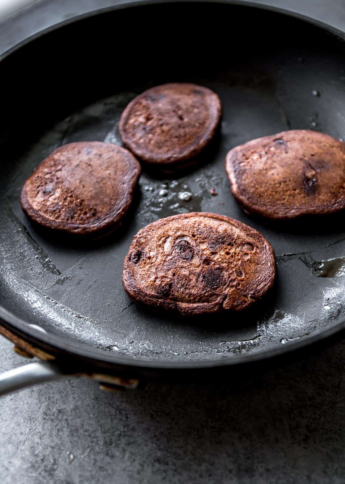 cooking pancakes in a large skillet