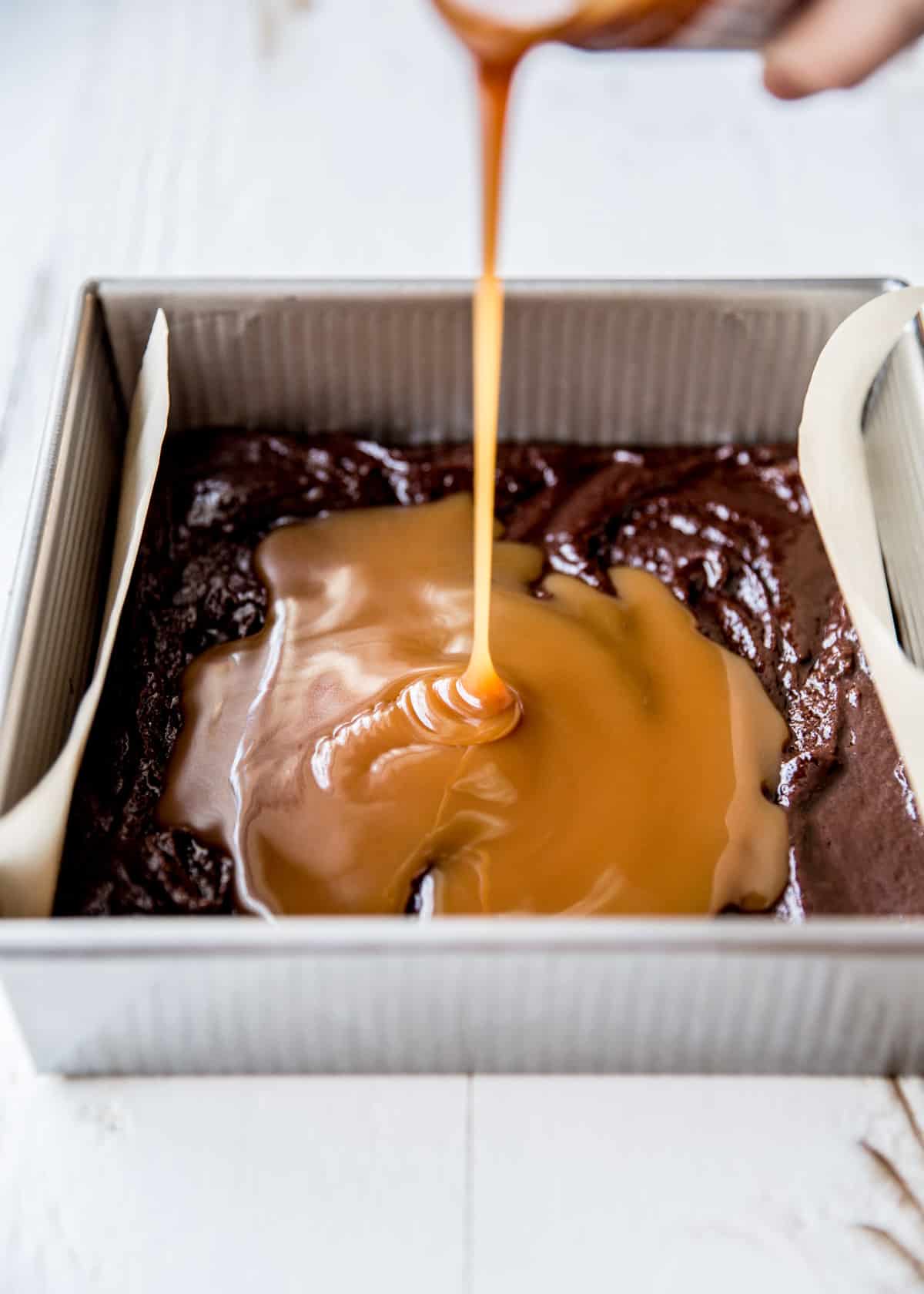adding salted caramel to brownie mixture
