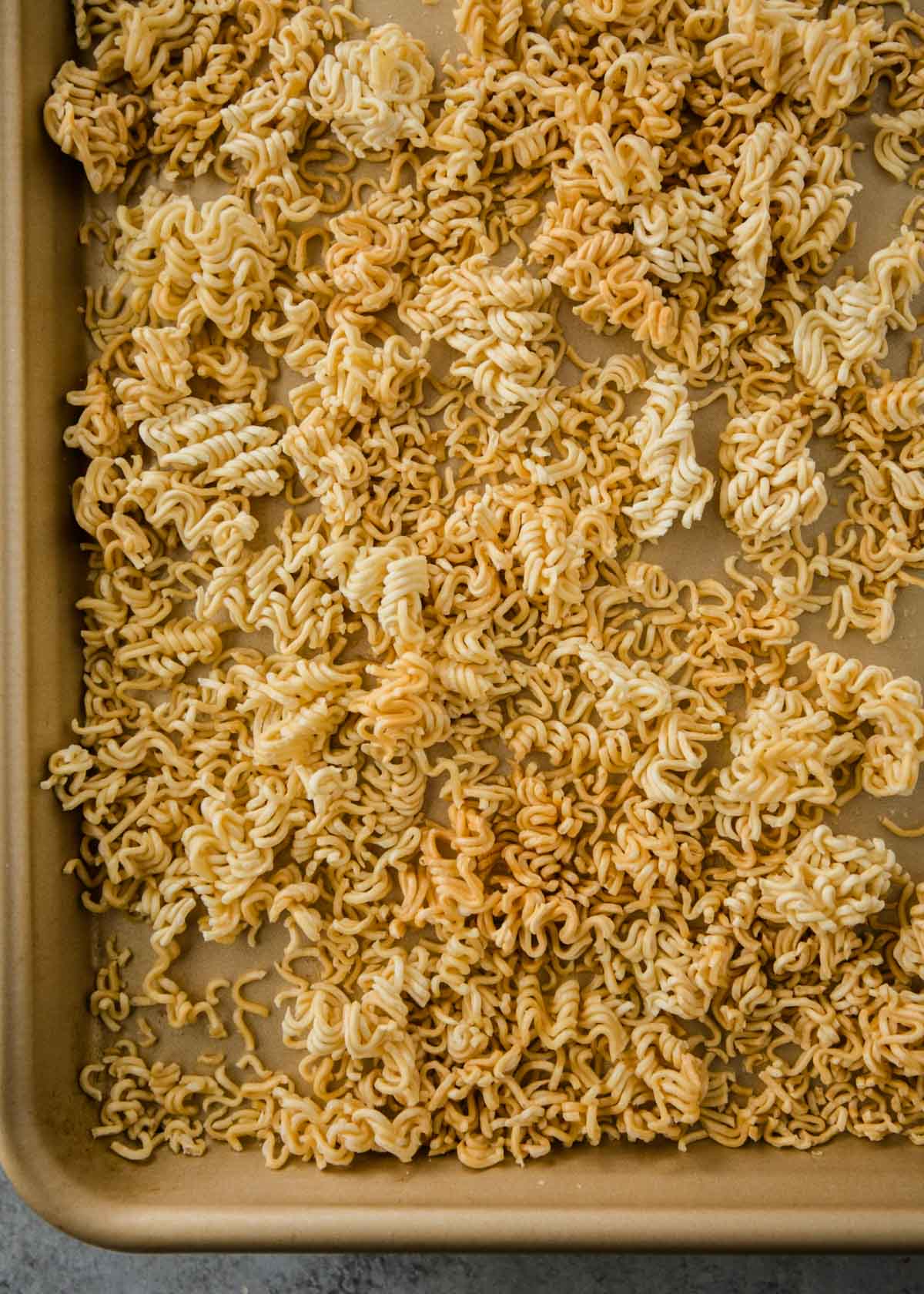 overhead image of toasted ramen noodles on a sheet pan