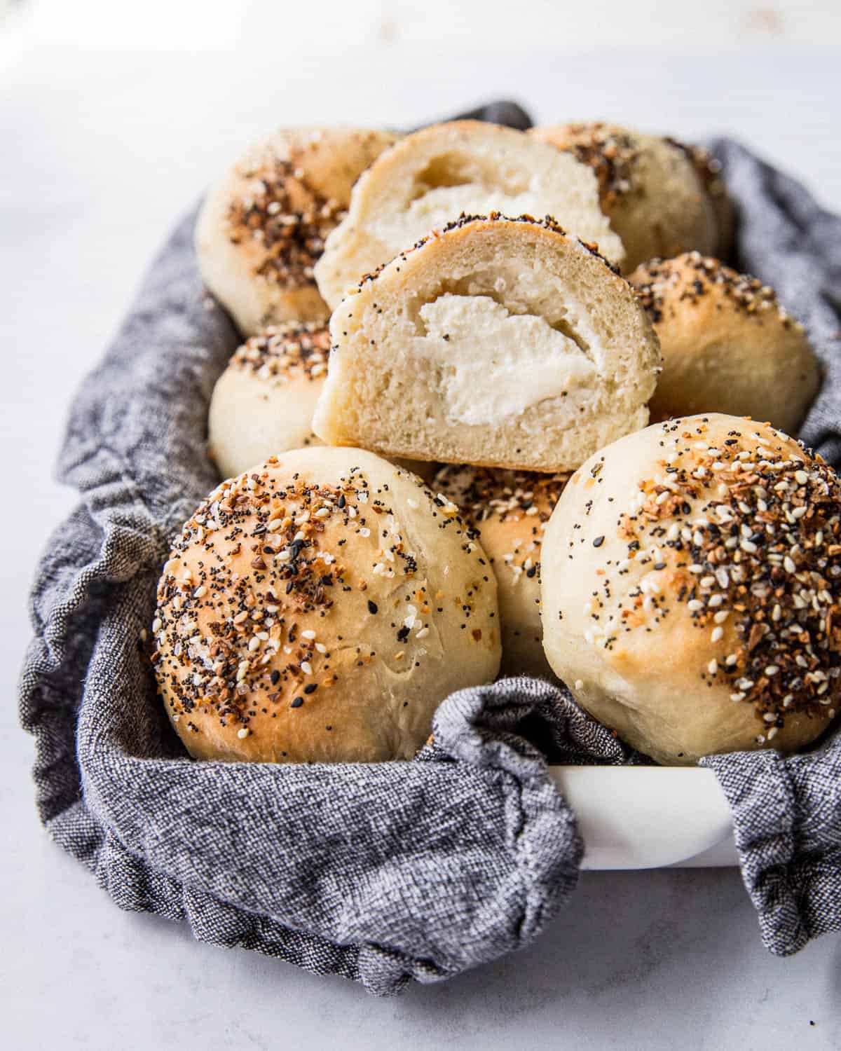 rolls filled with cream cheese in a towel lined basket