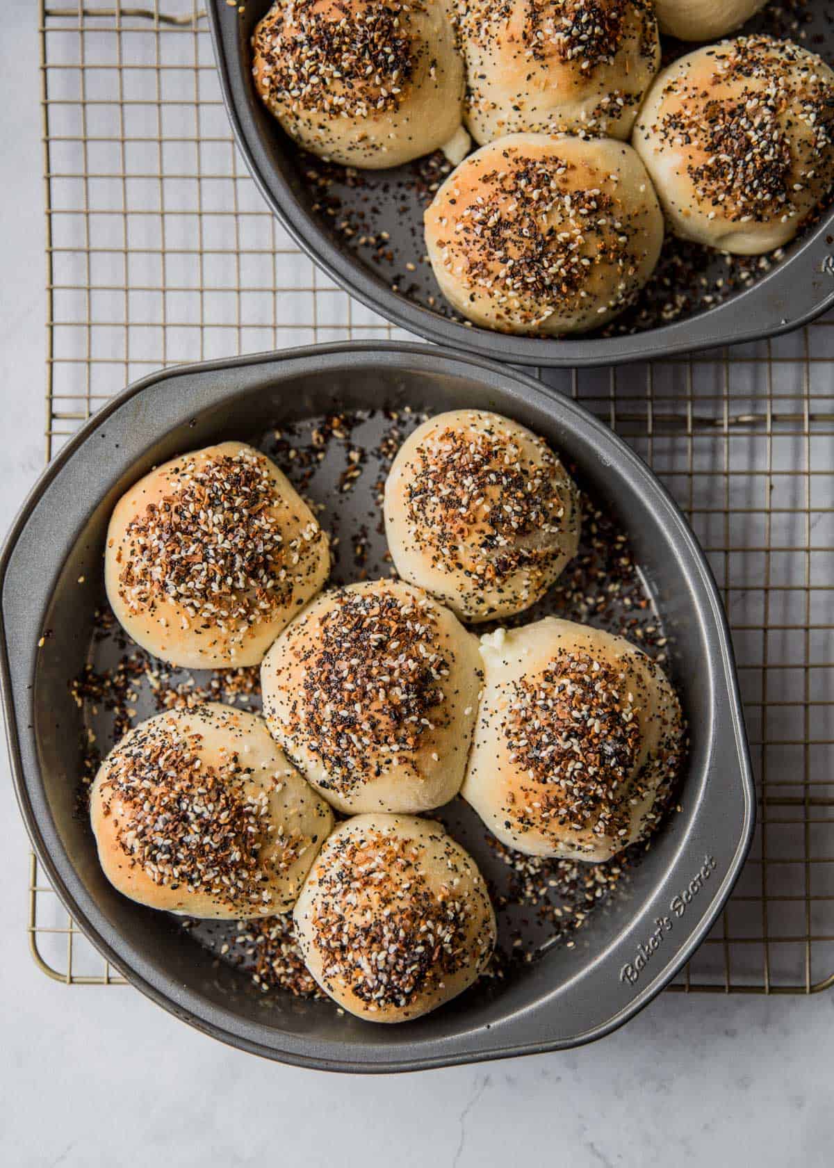 overhead image of baked rolls in a round baking pan