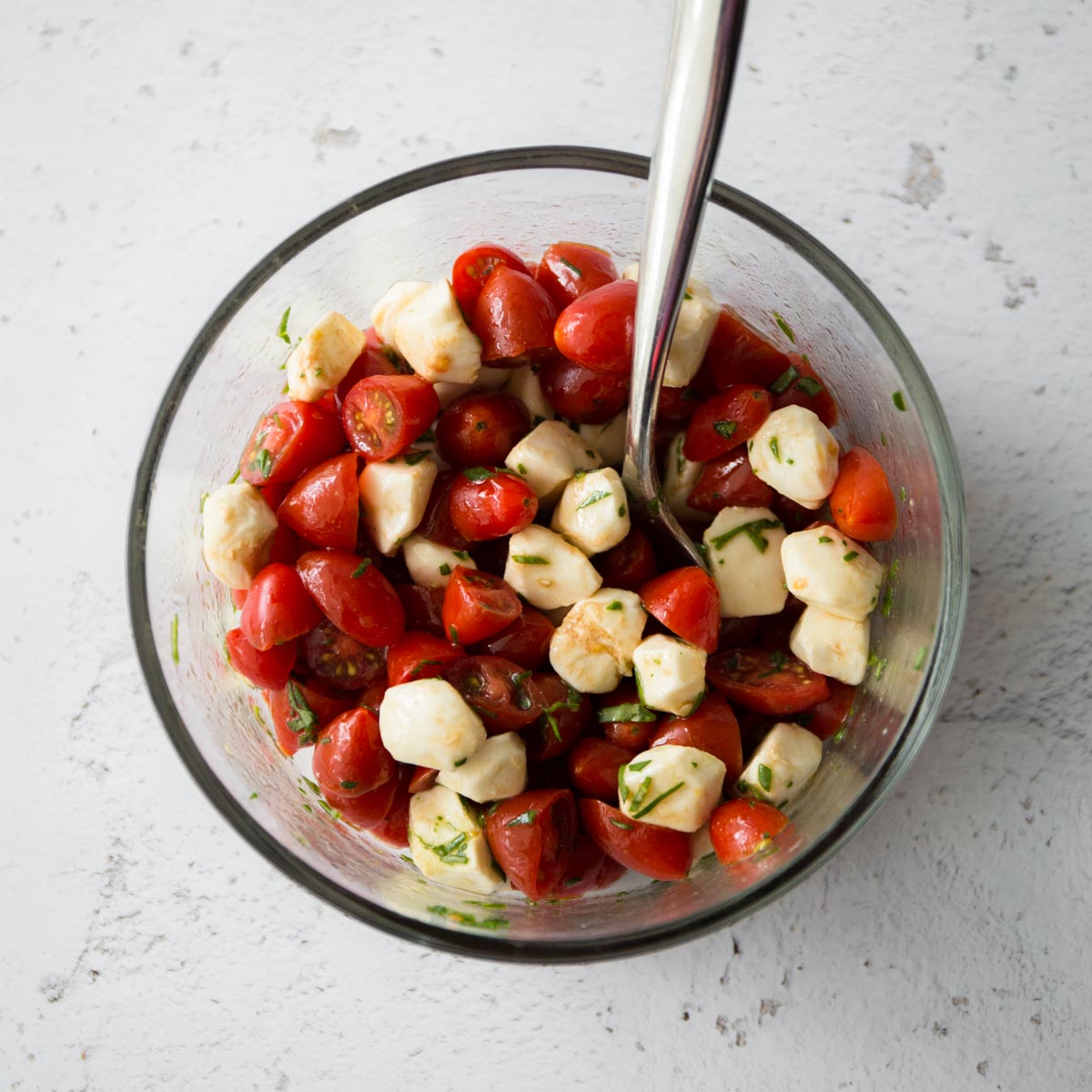 tomatoes and mozzarella in a clear glass bowl