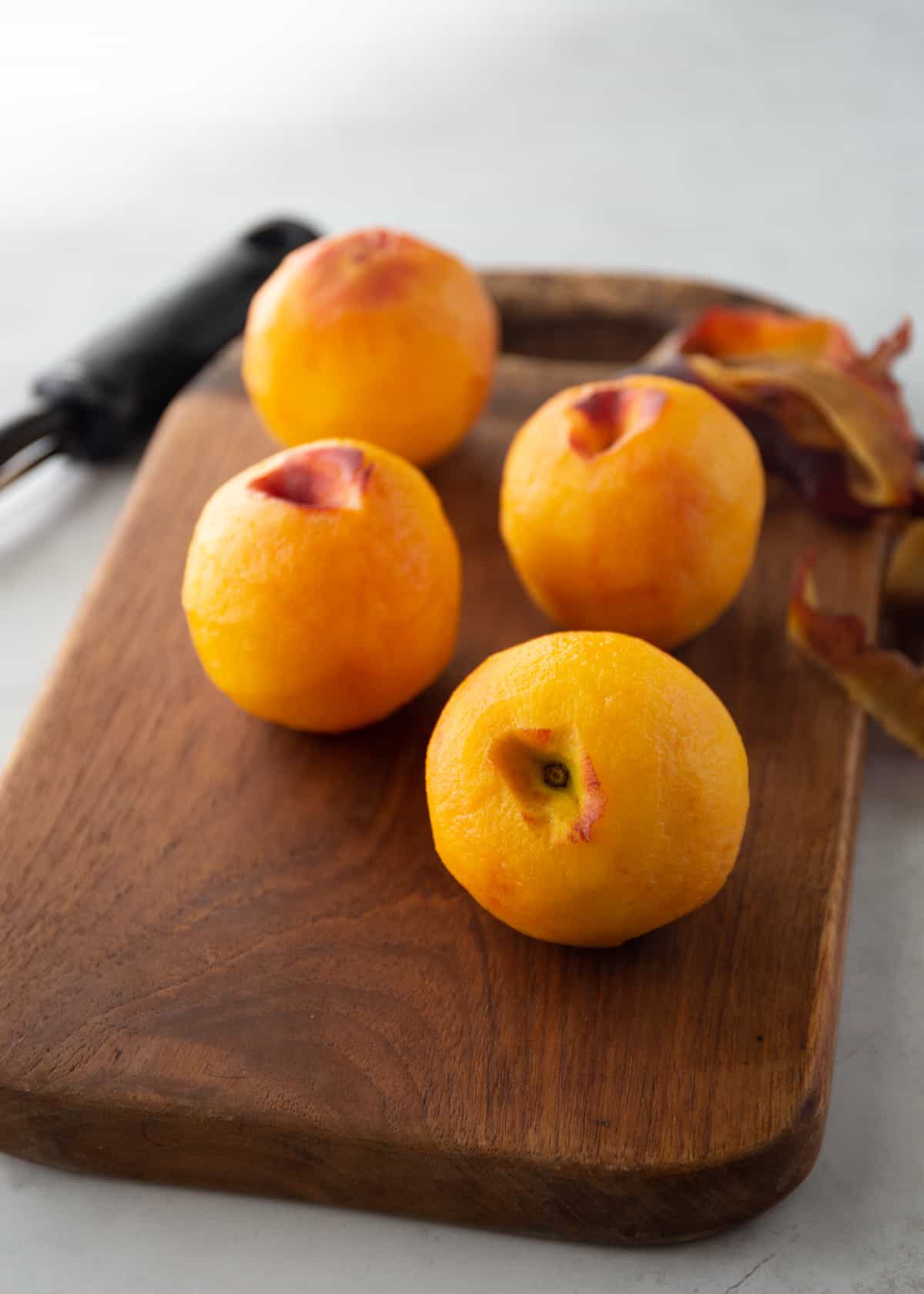 peaches on a wooden cutting board