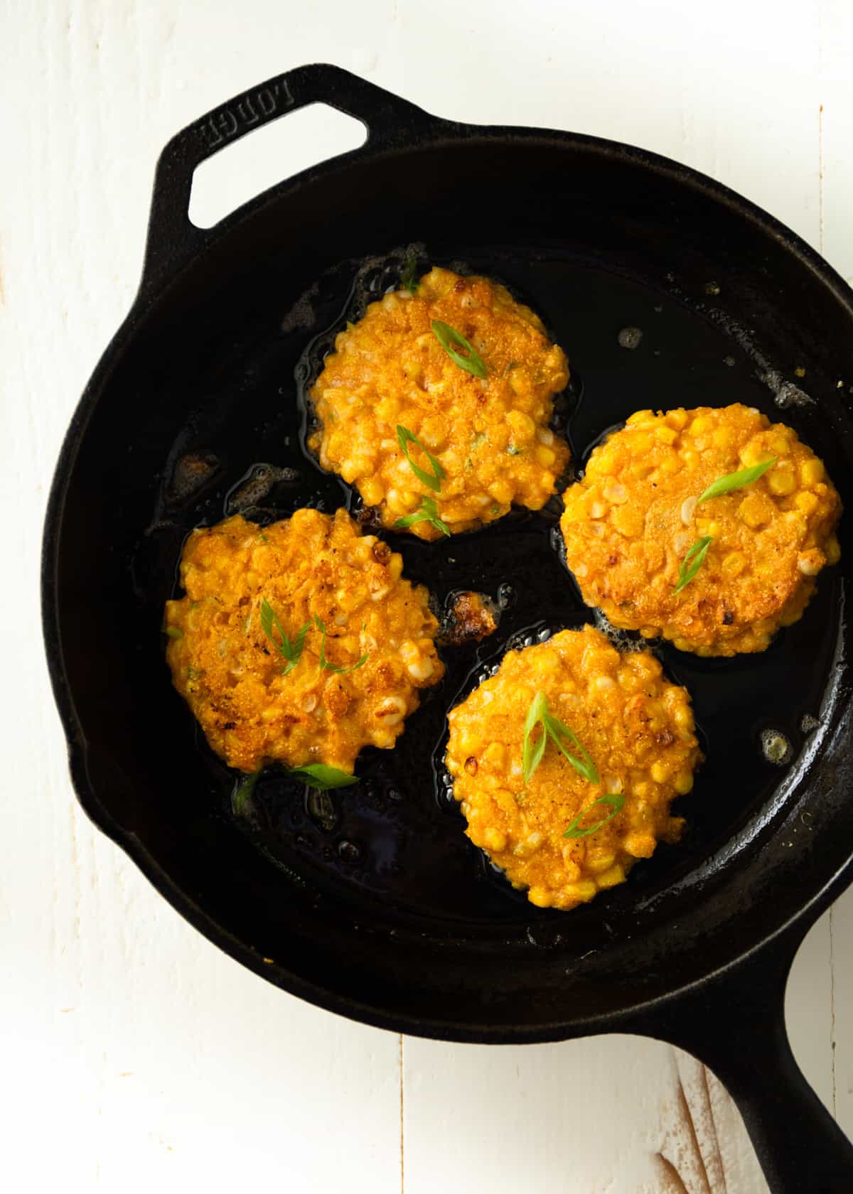 overhead image of fritters in a cast iron skillet