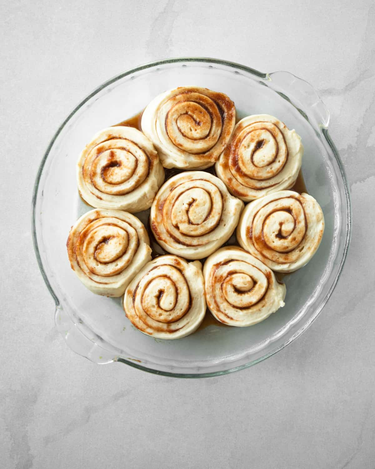 uncooked rolls in a clear baking dish