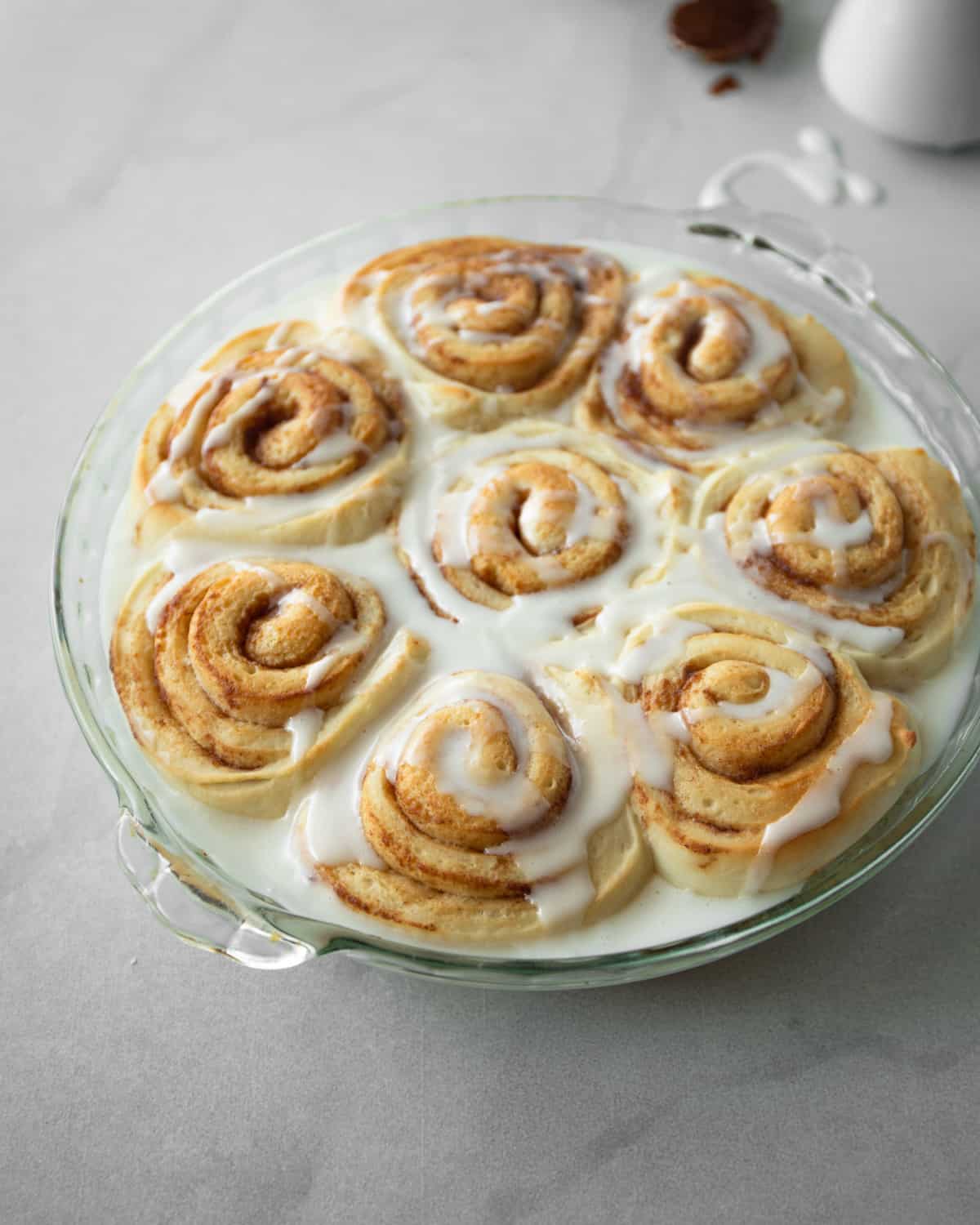 cinnamon rolls in a round clear baking dish