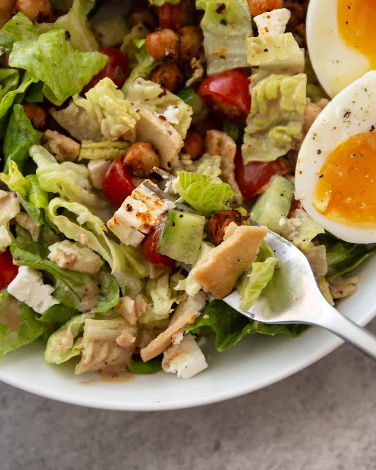 a fork in a bowl of fattoush salad