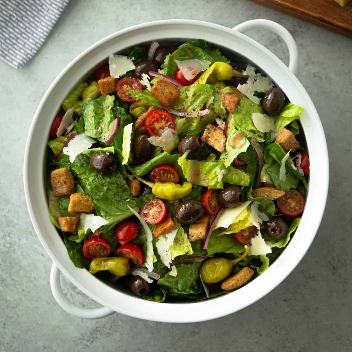 overhead image of Italian house salad in a large white bowl