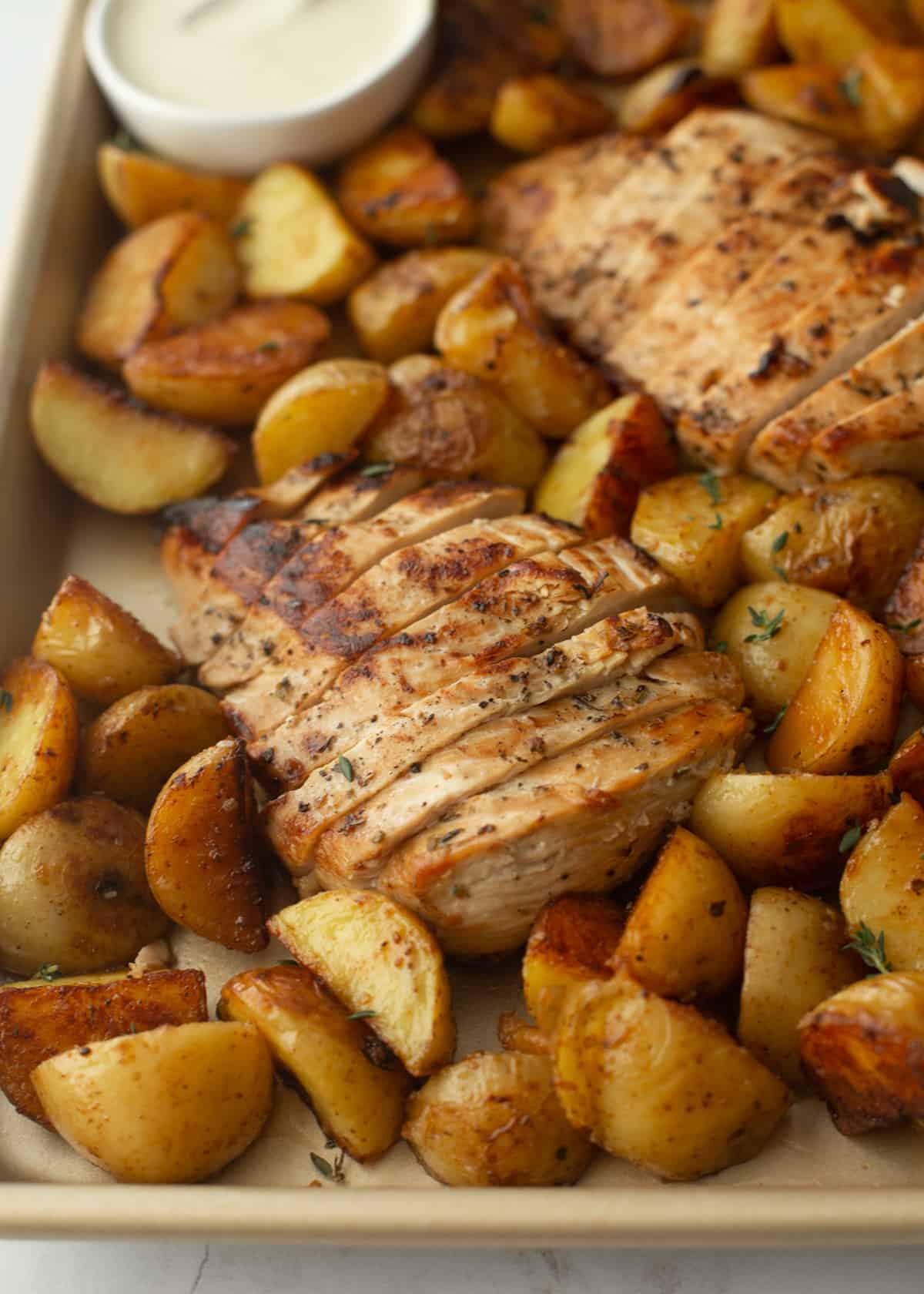 chicken and potatoes on a sheet pan