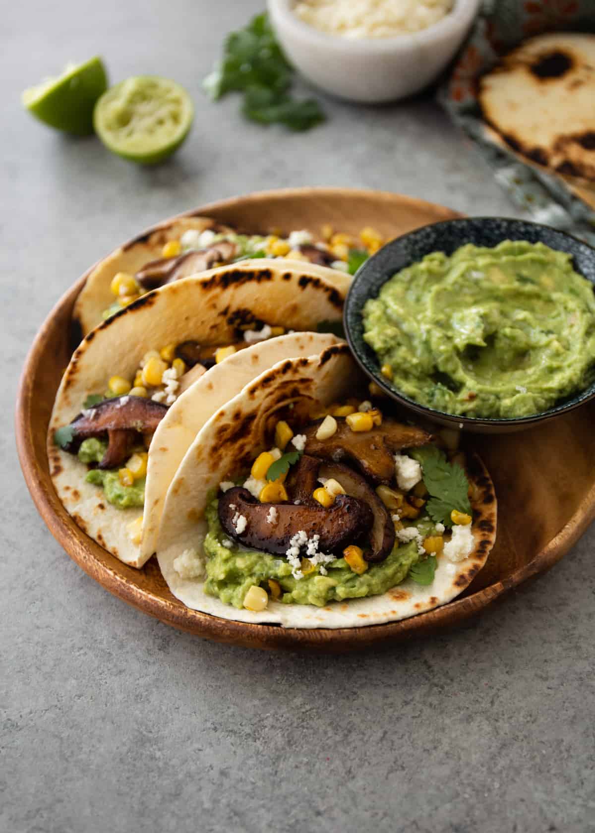 tacos and guacamole on a round plate