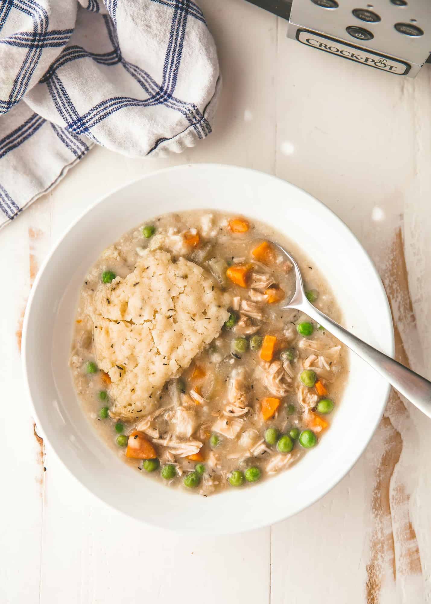 overhead image of slow cooker chicken and biscuits in a white bowl