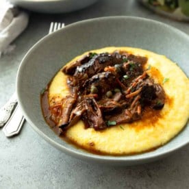 roast over polenta in a grey bowl