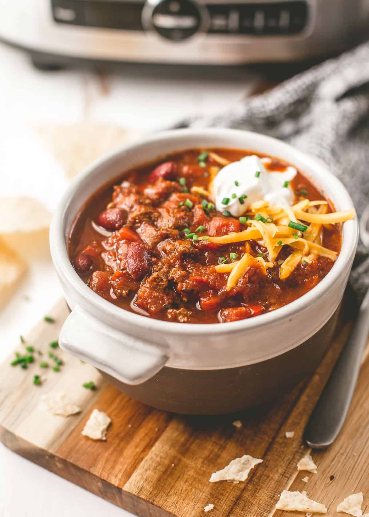 beef chili in a white and brown bowl