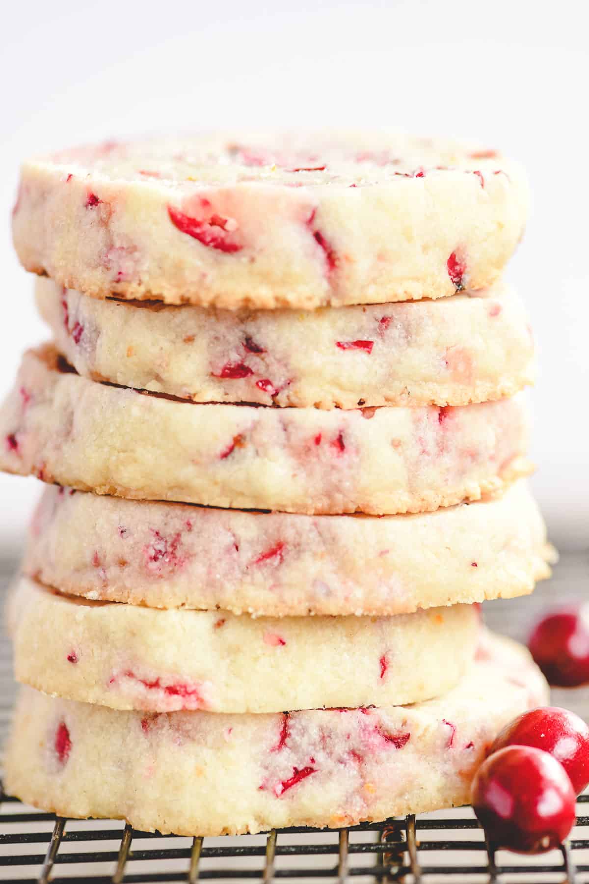 a stack of cranberry cookies on a wire rack