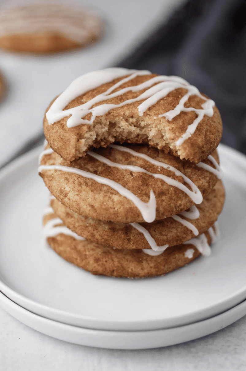 cinnamon roll cookies stacked on a white plate