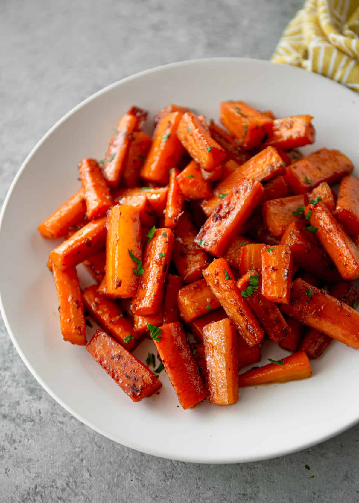 glazed carrots in a white bowl