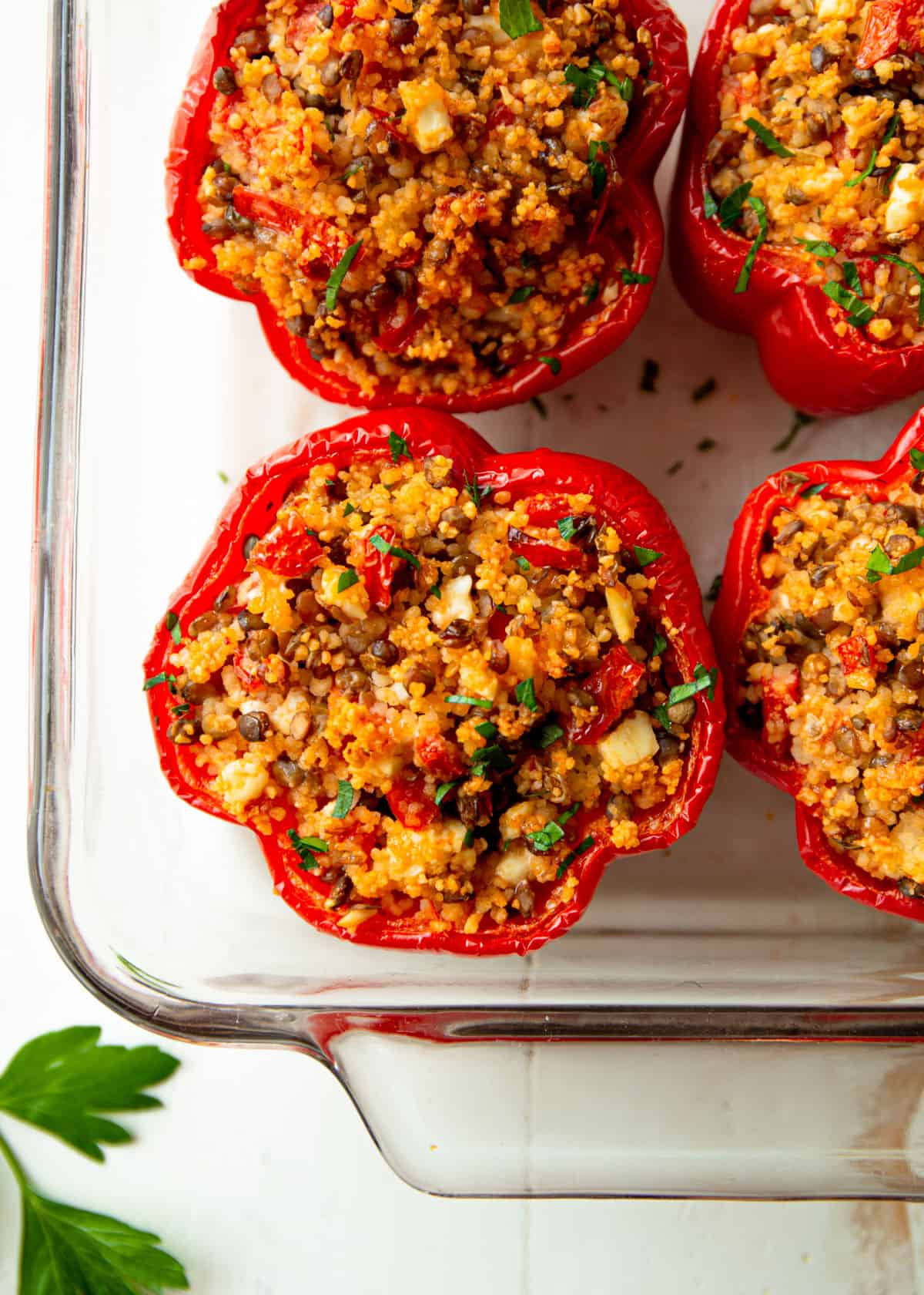 stuffed red peppers in a clear baking dish