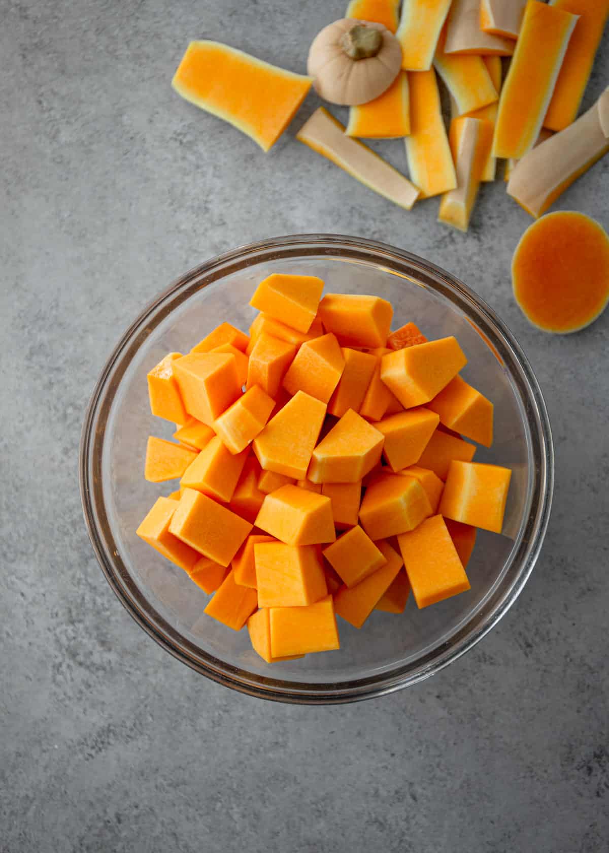 uncooked butternut squash in a clear bowl